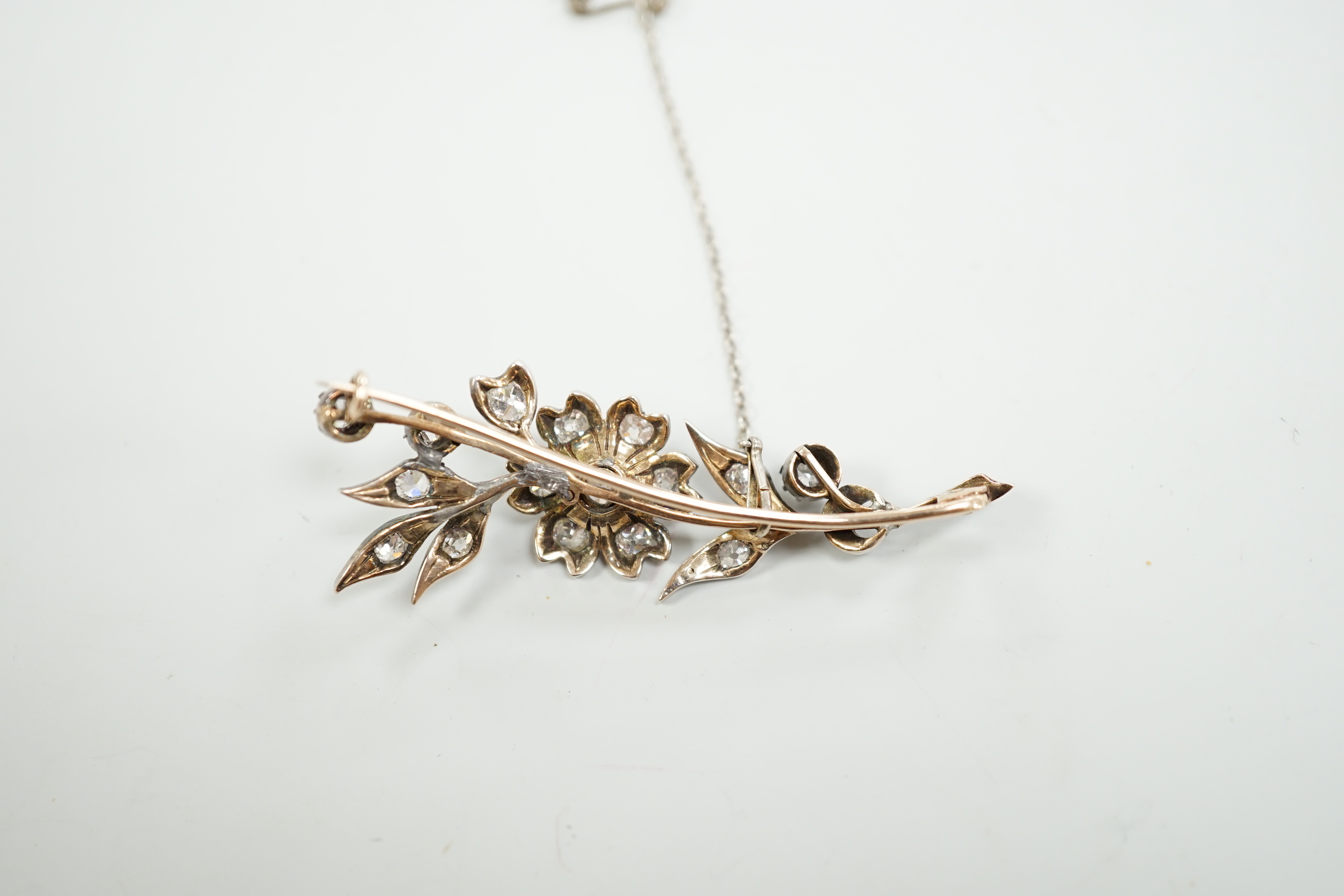 A Victorian yellow and white metal, diamond cluster set floral spray brooch, 56mm, gross weight 8.1 grams.